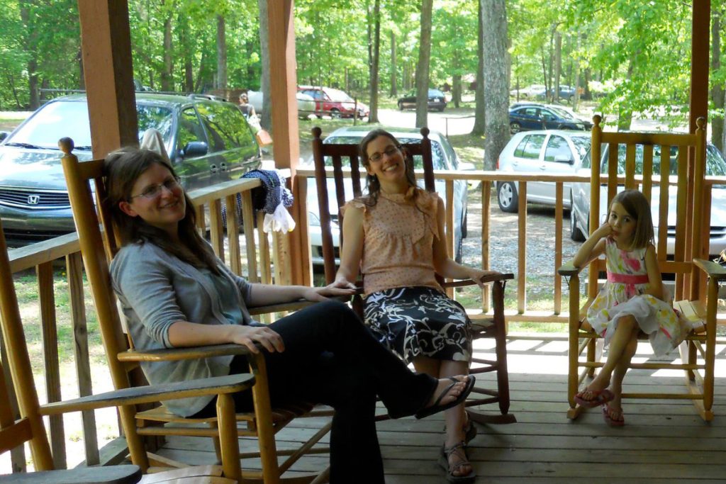 People gathered on the porch at Chapel Hill Mennonite Fellowship